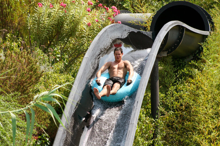 Boy on a tube on the Black Hole slide