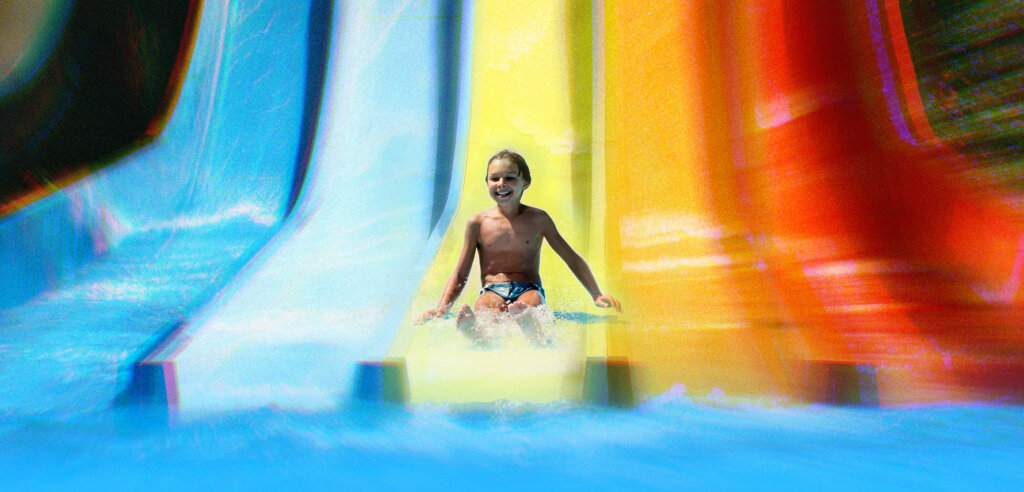 Boy racing down the Multi Slide